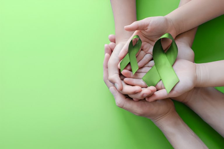green ribbons resting on hands